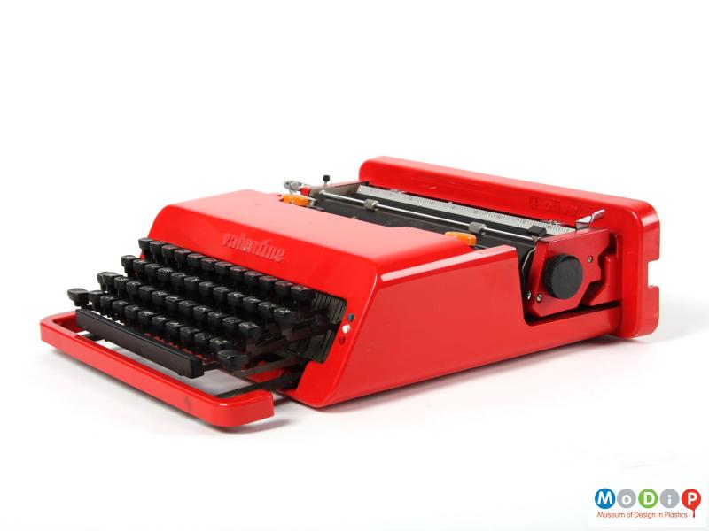 Side view of a Valentine typewriter showing the red body and black keys.