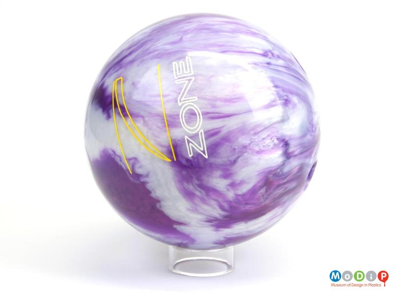 Side view of a bowling ball showing the printed logo.