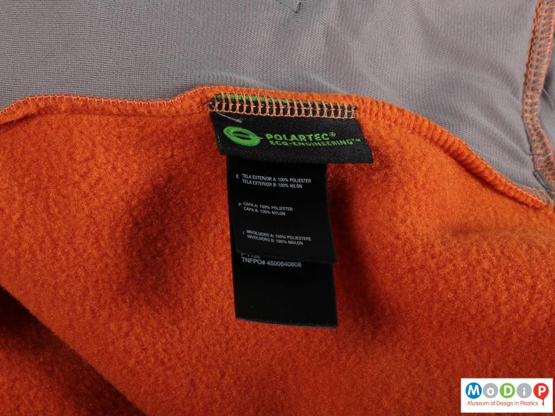 Close view of a jacket showing the fleece fabric and label.