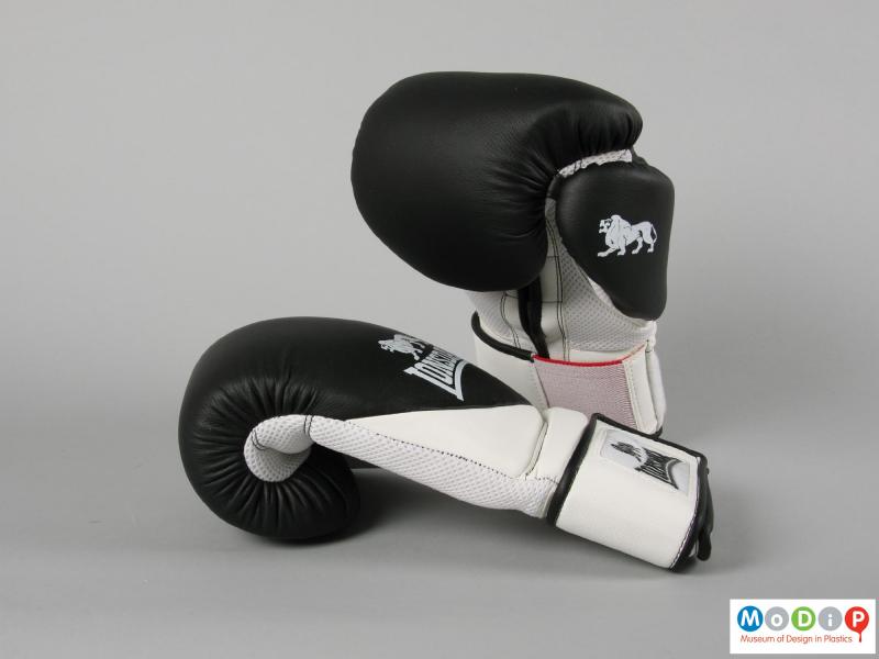 Side view of a pair of boxing gloves showing thickness of the padding.