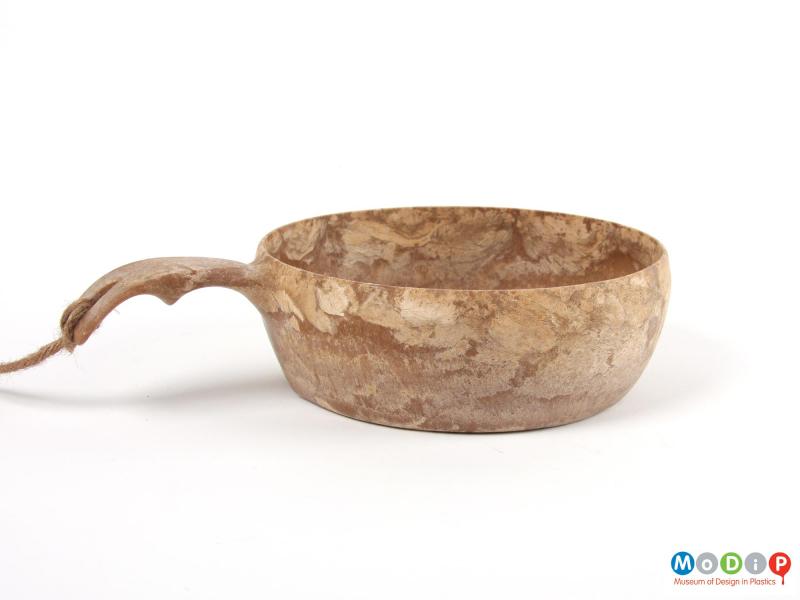 Side view of a bowl showing the curved handle.