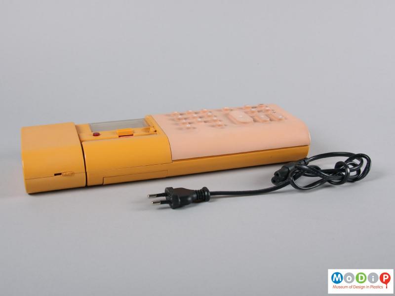 Side view of a calculator showing the power cable.