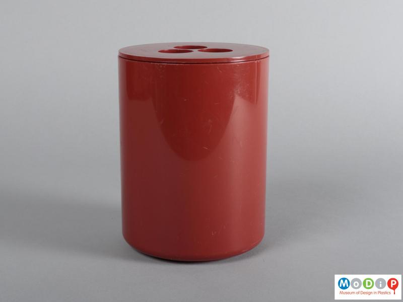 Side view of a container showing the tall cylindrical shape.