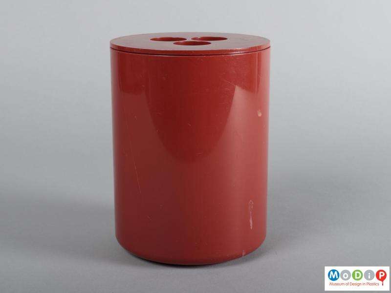 Side view of a container showing the tall cylindrical shape.