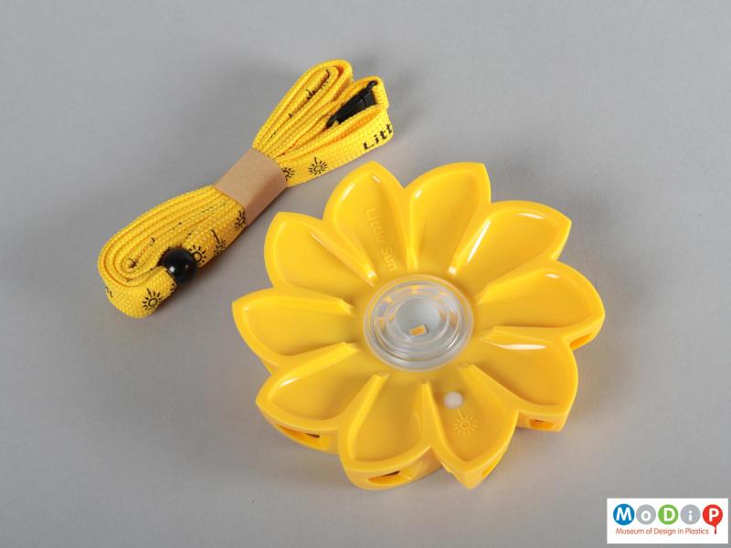 Front view of a light showing the flower shape and the lanyard.