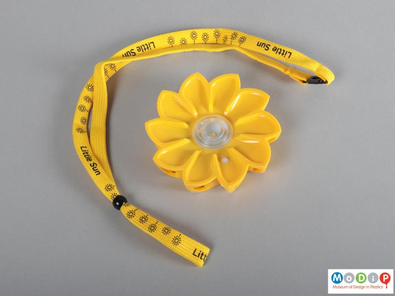 Front view of a light showing the flower shape and the lanyard.