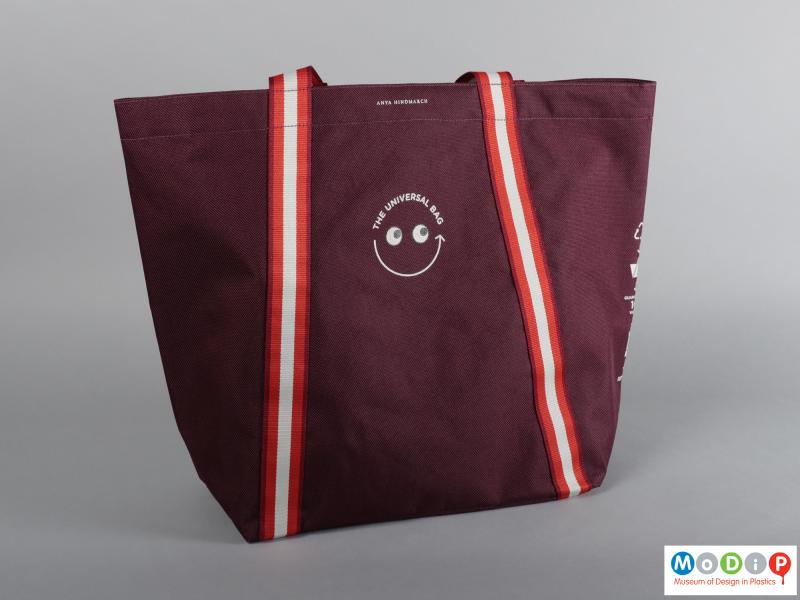Front view of a bag showing the emblem with a smiley face.