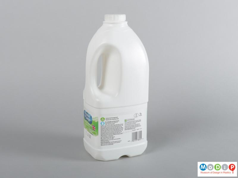 Side view of a milk bottle showing the rectangular profile.