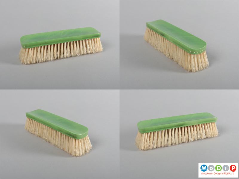 Side view of a grooming set showing four different views of the clothes brush.
