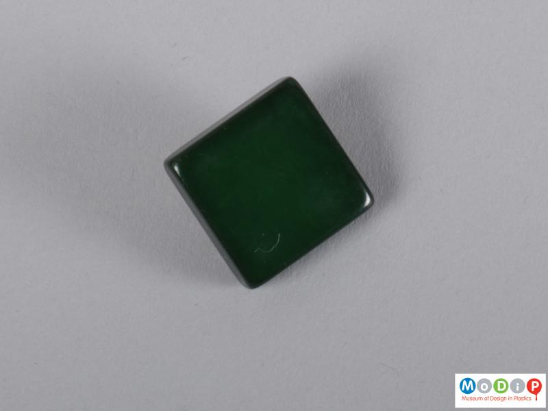 Front view of a button showing the square shape.