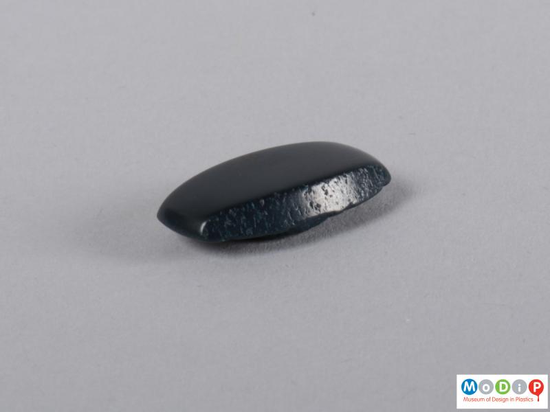 Side view of a button showing the chamfered edges.