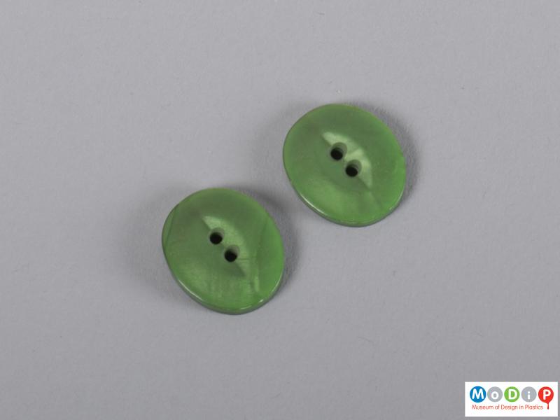 Underside view of a group of buttons showing the two holes.