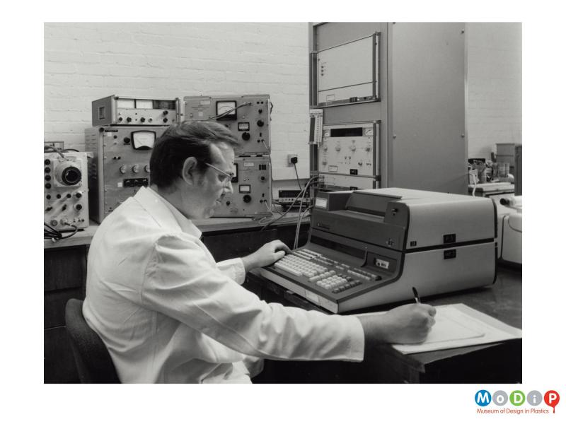 Scanned image showing a man using scientific equipment.