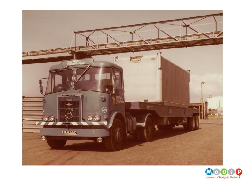 Scanned image showing a lorry with a container on the back.