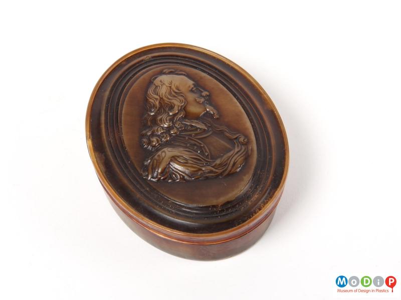 Top view of a snuff box showing the moulded portrait.