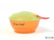 Side view of a Tommee Tippee weaning set showing the lid on the bowl and the spoon in the slot on the lid.
