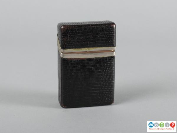 Front view of a cigarette case showing the metal trim.