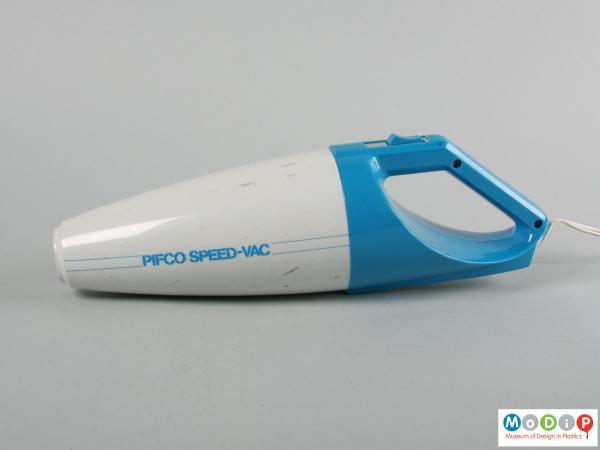 Side view of a vacuum cleaner showing the grey and blue body.