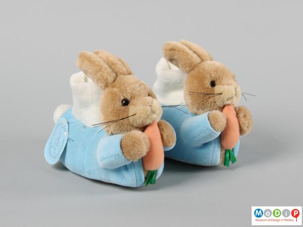 Front view of a pair of slipper showing the rabbit figures on the toe.