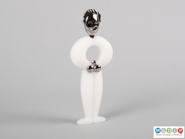 Side view of a bottle opener showing the facial features and limbs.