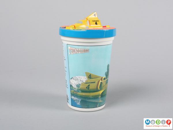 Side view of a beaker showing the moulded vehicle on the lid.