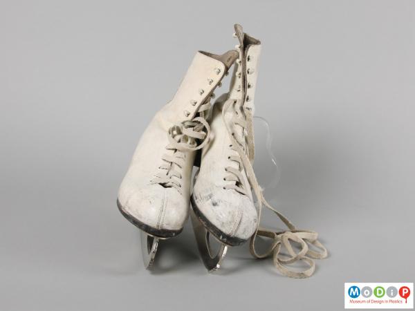 Front view of a pair of ice skates showing the laces.