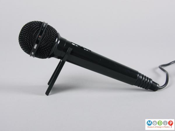 Side view of a microphone showing it on the small stand.