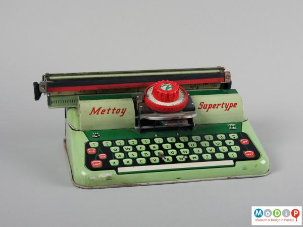 Front view of a toy typewriter showing the flat plate body.