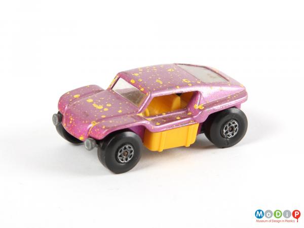 Side view of a toy vehicle showing the wheels and wide side opening.