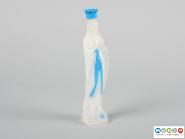 Front view of a holy water bottle showing the figure with hands in a prayer position.