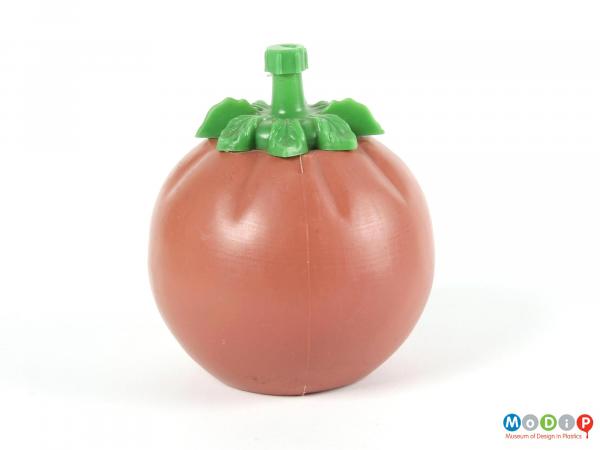 Side view of a tomato sauce bottle showing the round bottle with leaf shaped lid.