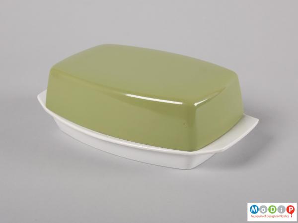 Side view of a butter dish showing the handles on the base.