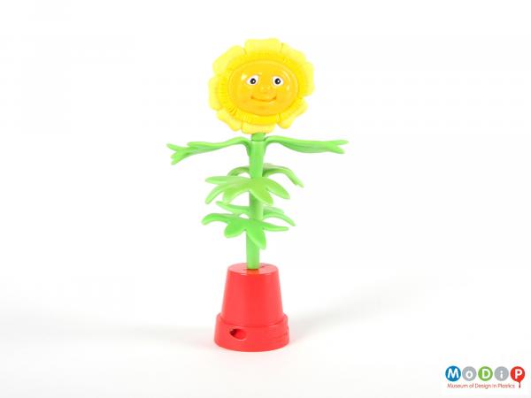 Front view of a toy showing the face of the flower head.