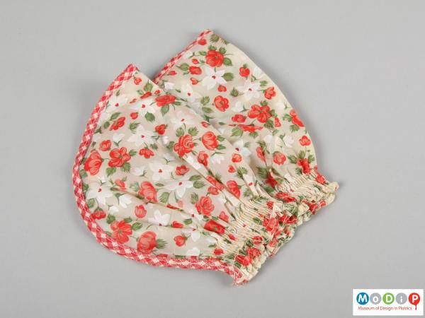 Side view of a pair of sleeve protectors showing the floral print.