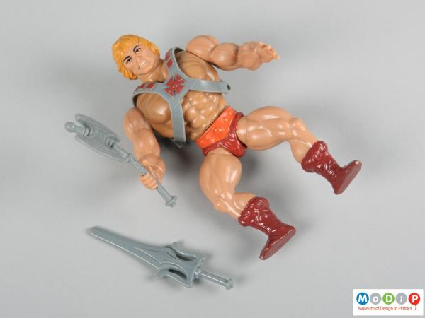 Front view of a character doll showing the muscle definition of the body.