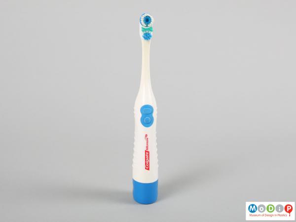 Front view of a toothbrush showing the control buttons and bristle pattern.