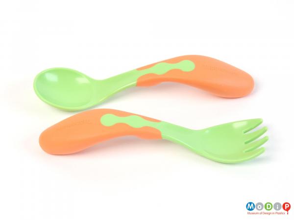 Top view of a child's fork and spoon set showing the soft grip handle and smooth bowl surface.
