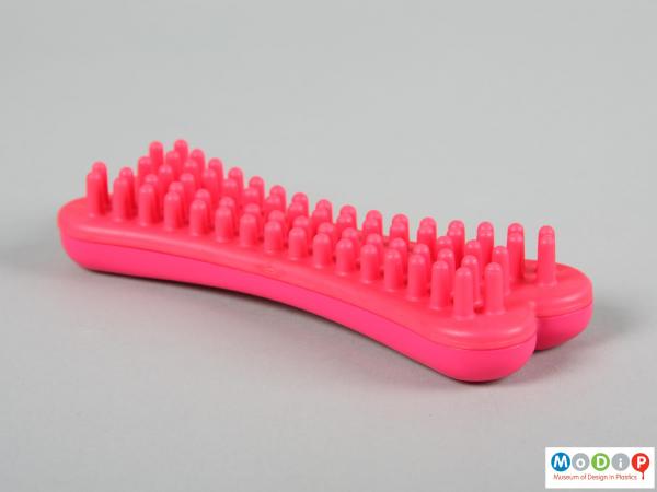 Side view of a dog brush showing the large bristles.