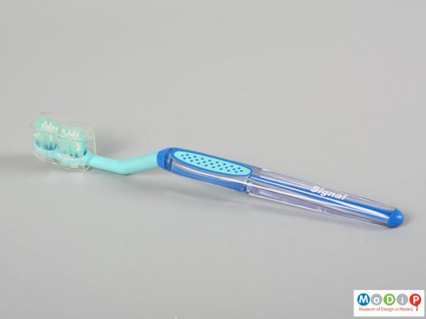 Side view of a toothbrush showing the angled handle.