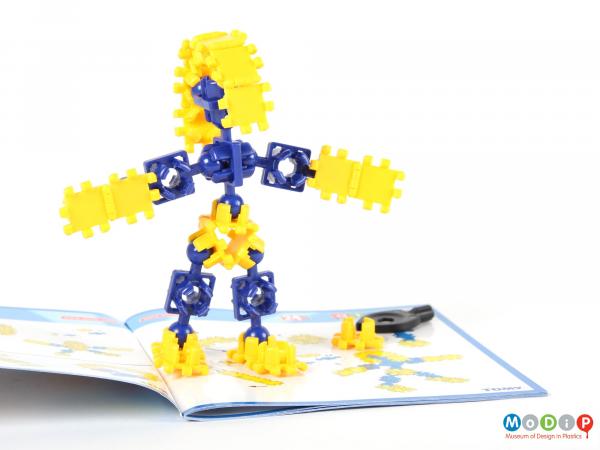 Side view of an Atollo construction set showing a figure made from the pieces.