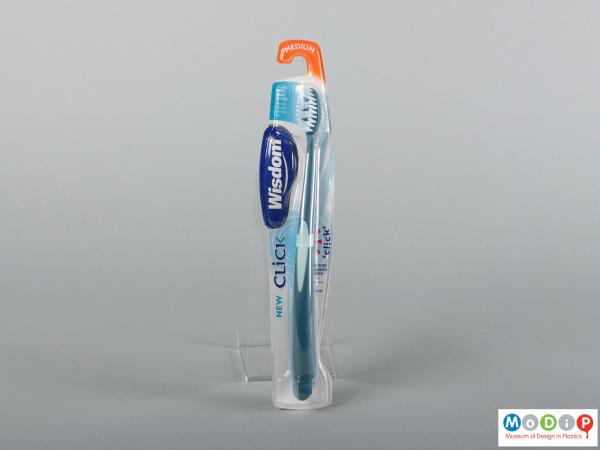 Front view of a pair of packaged toothbrushes showing the handles and bristles.