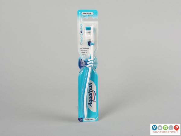 Front view of a toothbrush showing the straight handle.