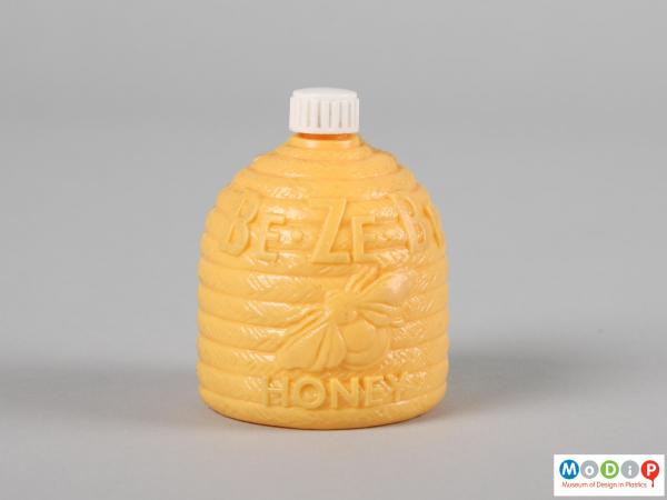 Front view of a Be Ze Be Honey bottle showing the moulded inscription and bee.