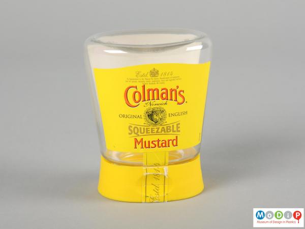 Front view of a Colman's Mustard jar showing the fluted side and flat lid.