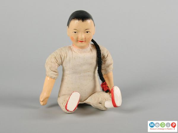 Front view of a doll showing the painted facial features.