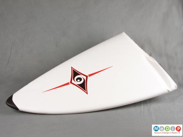 Front view of a surfboard section showing the logo.
