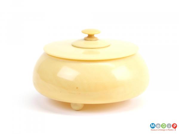 Side view of a powder bowl showing the flat lid and finial.
