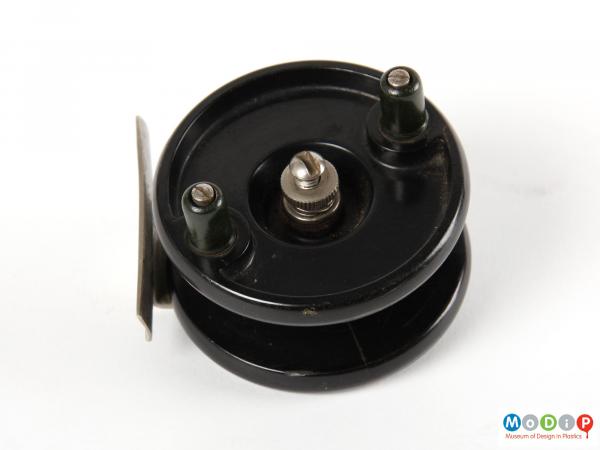 Side view of a fishing reel showing the circular shape.