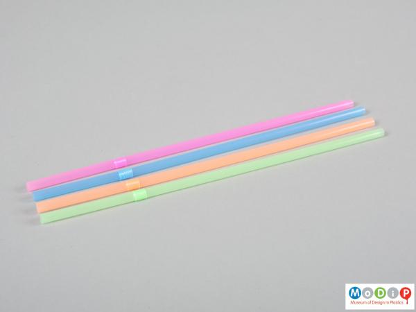 Side view of a box of drinking straws showing the four different colours.