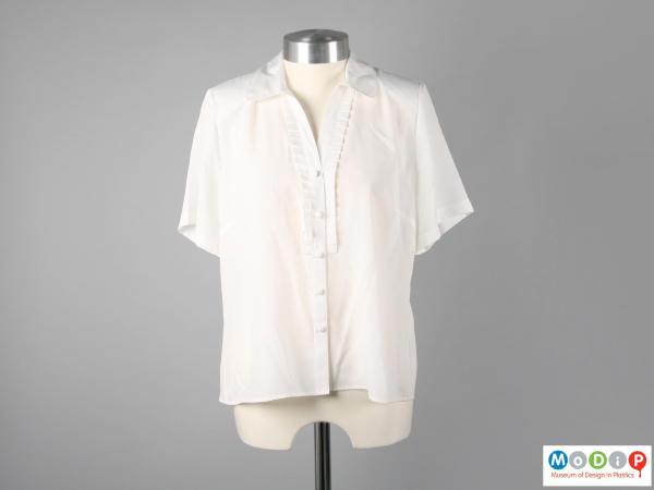 Front view of a blouse showing the button fastening.
